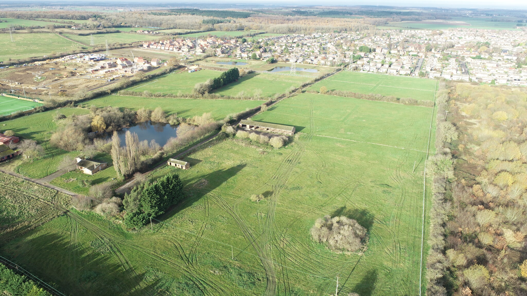 Barratt Homes and David Wilson Homes site before preparatory earthworks, with lots of open space and greenery, with an unrecorded landfill hidden on the site.