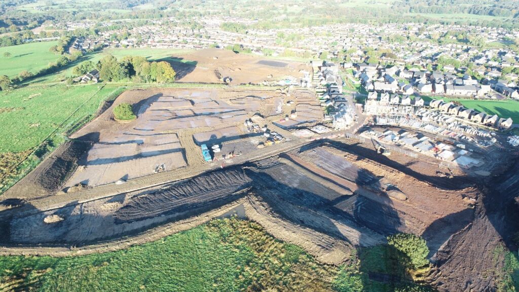 Shot of greenfield development site that underwent work complete by BSH Remediation, situated next to a housing estate for more housing.